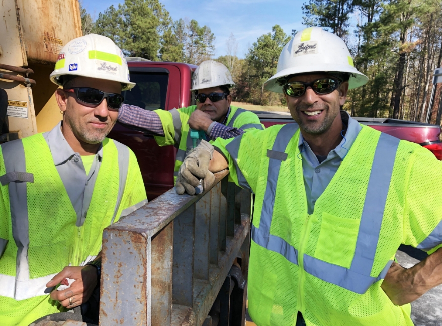 two male workers smiling at camera