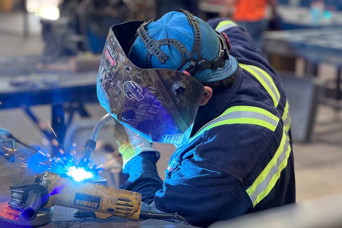 man welding with protective gear on
